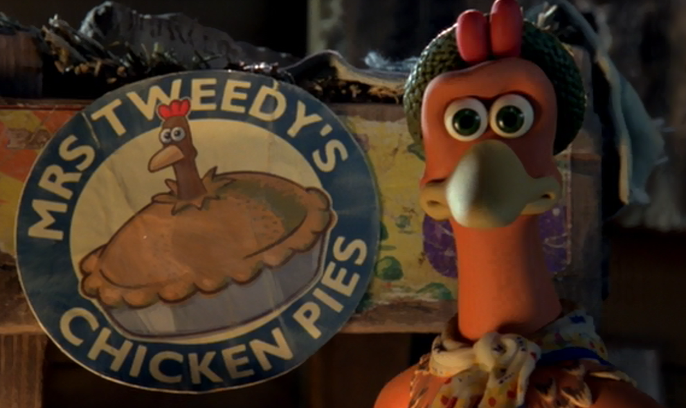 Auto-generated description: A claymation chicken stands next to a Mrs. Tweedy's Chicken Pies sign with a concerned expression.